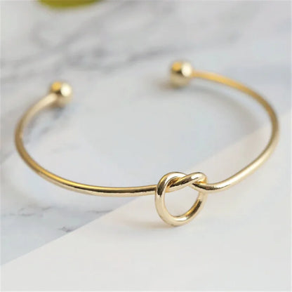 Elysian Cuff – A minimalist gold cuff with refined elegance.